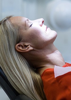 Relaxing woman with eyes closed in dental chair