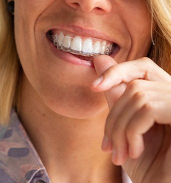 barely visible tray going into a blonde woman’s mouth
