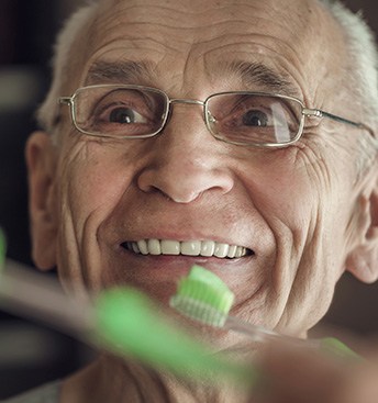 senior man brushing his teeth