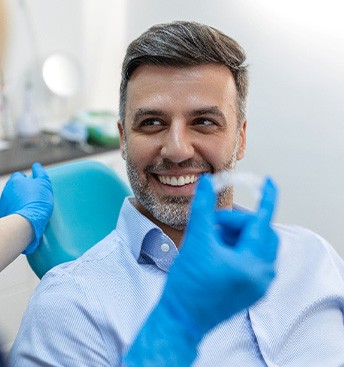 dentist holding Invisalign with patient