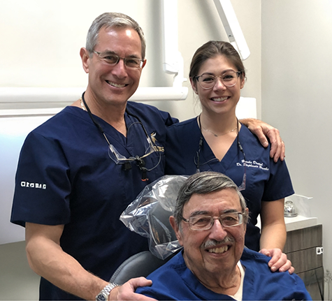 Three smiling dental team members