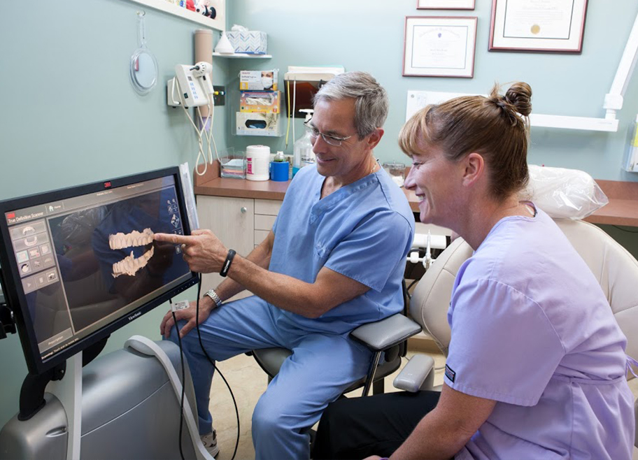 Dr. Brooks and dental team member looking at computer