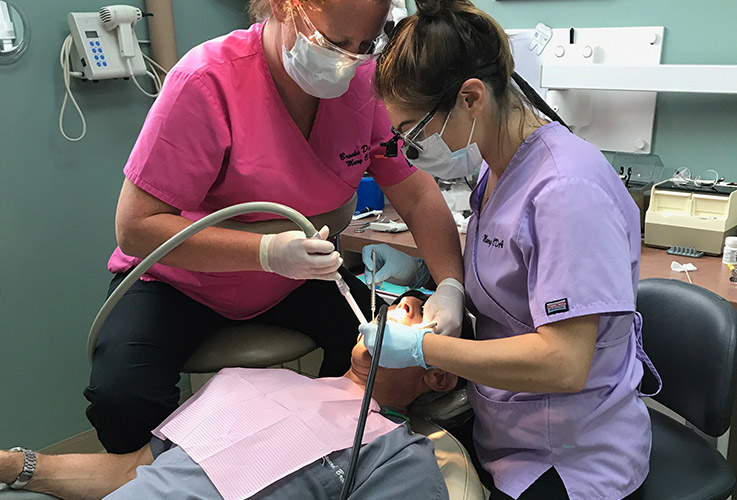 Two team members treating patient