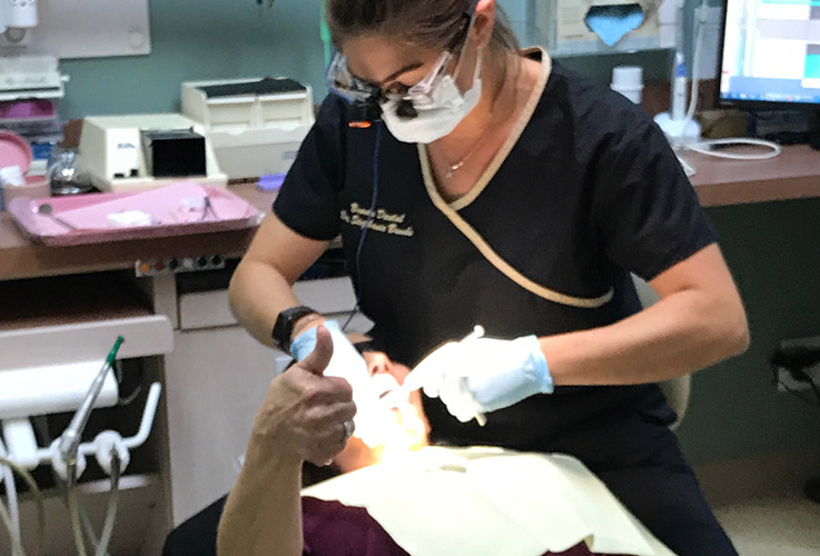Patient giving thumbs up during dental treatment