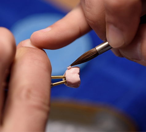 Dental lab technician designing a dental crown