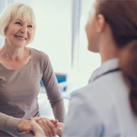 Patient and dentist discussing the price of dental implants in Winthrop 