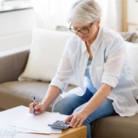 Woman reviewing her dental insurance coverage for dental implants in Winthrop 