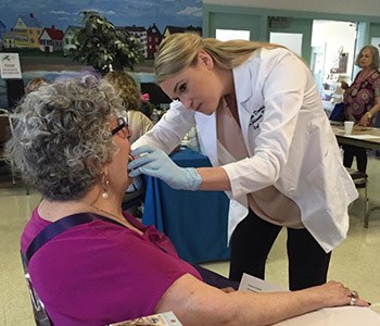 Dr. Brooks examining older female patient