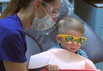 Child working with dental hygienist