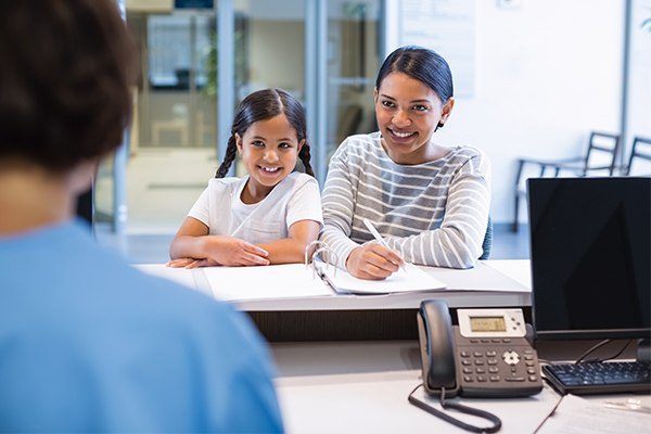 Dental staff speaks to patient