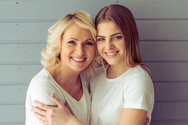 Mother and daughter smiling