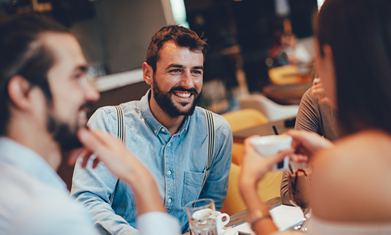 Four friends enjoying a meal at a restaurant