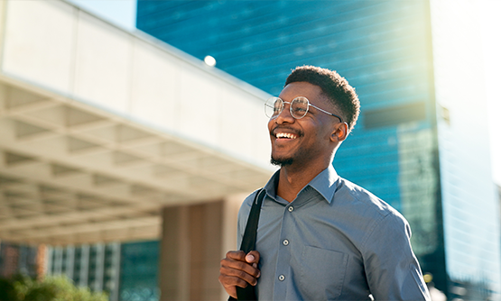 Smiling man on a city sidewalk