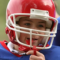 Young boy with red sports mouthguard