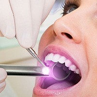 Woman receiving oral cancer screening