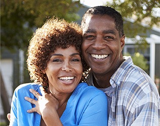 Smiling man and woman outdoors