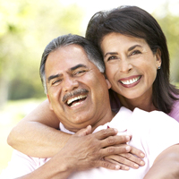 couple smiling hugging dental implant near Revere