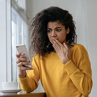 surprised woman looking at her phone 