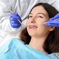 smiling teen getting a dental exam 