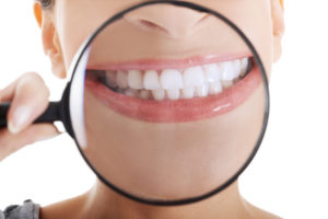 woman smiling with magnifying glass