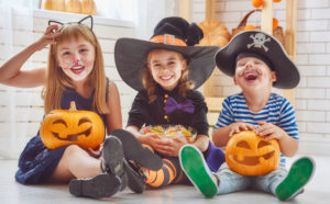 Smiling children in Halloween costumes