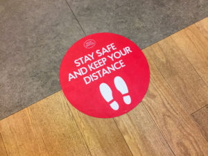 Floor sign encouraging social distancing at your Winthrop dentist practice