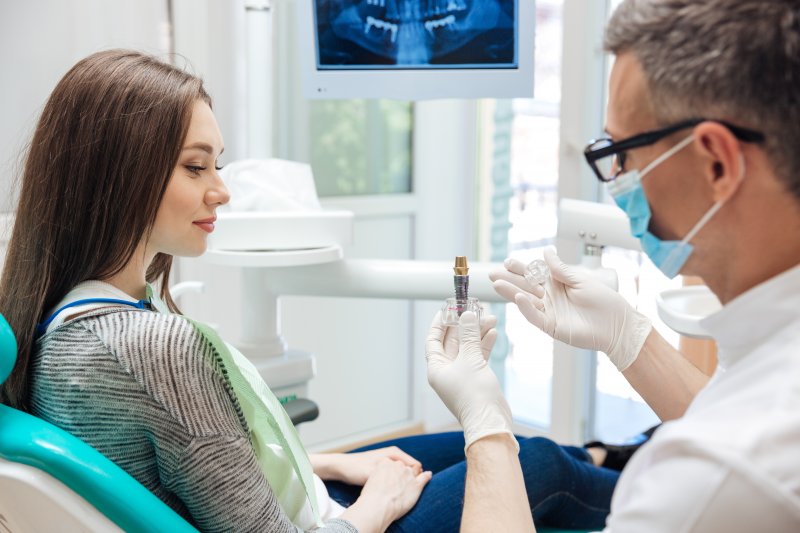 Dentist explaining dental implants in Revere