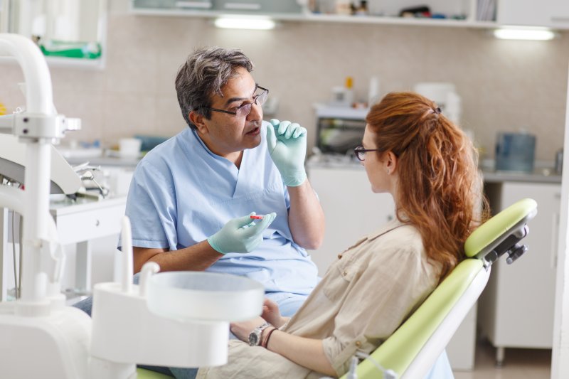 Dentist talking to patient about implant alternatives