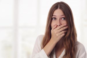 woman covering her mouth because of dental TikTok trends