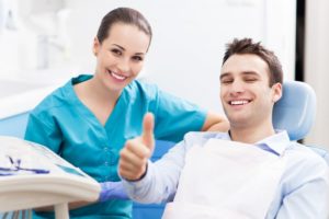 man giving a thumbs up at his dental checkup