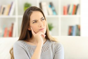 woman thinking about choosing professional teeth whitening