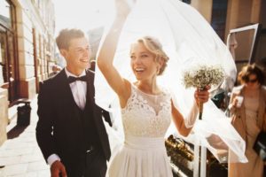 smiling bride and groom who did professional teeth whitening for wedding