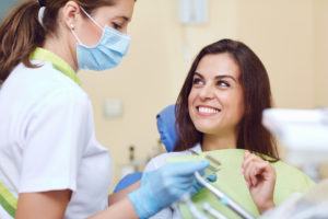 patient and dentist talking about the importance of early detection at checkup